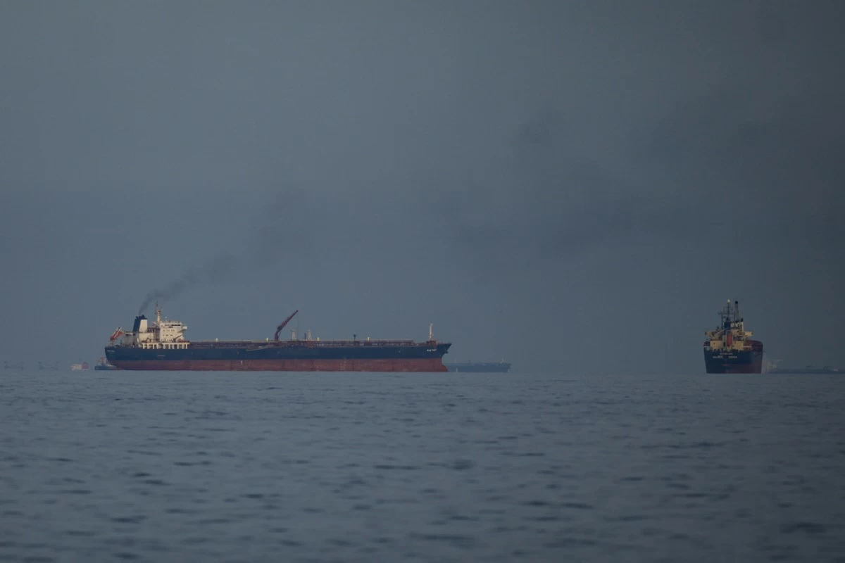 Oil tankers and cargo ships line up in the Strait of Hormuz as seen from Khor Fakkan, United Arab Emirates, Wednesday, March 11, 2026. (AP Photo/Altaf Qadri)