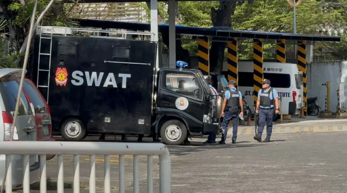 POLICE inspect the vicinity of Saint John’s Institute-Hua Ming in Bacolod City following a mass shooting threat on Thursday, March 12. (Adrian Prietos)