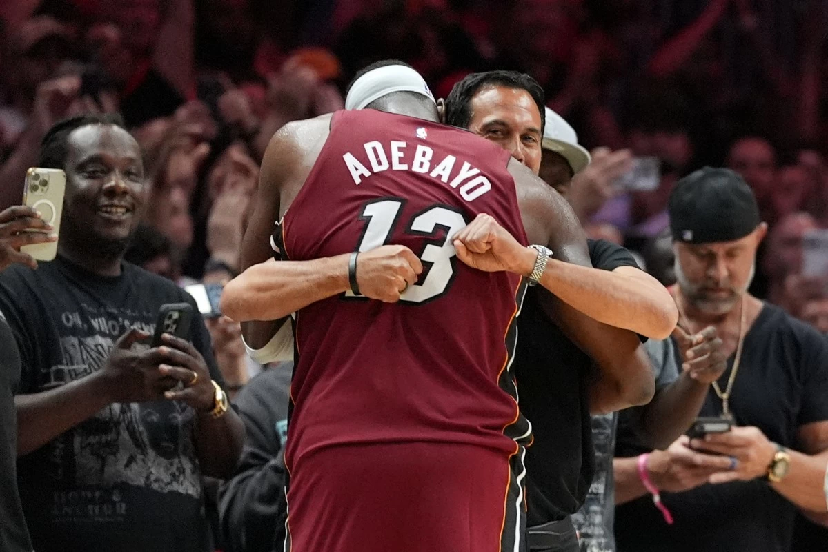 Miami Heat head coach Erik Spoelstra hugs center Bam Adebayo (13) as he leaves the game after scoring 83 points, the second-highest single game total in NBA history, in the second half of an NBA basketball game against the Washington Wizards, Tuesday, March 10, 2026, in Miami. (AP Photo/Rebecca Blackwell)