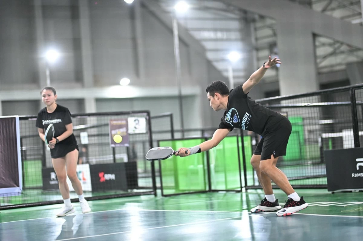 Clint Ontal reaches out for a return as teammate Jeanette Eduave looks on during their gold medal match against Patrick Laput and Abe Tomoti in mixed doubles 20  division of the High Intermediate category.

