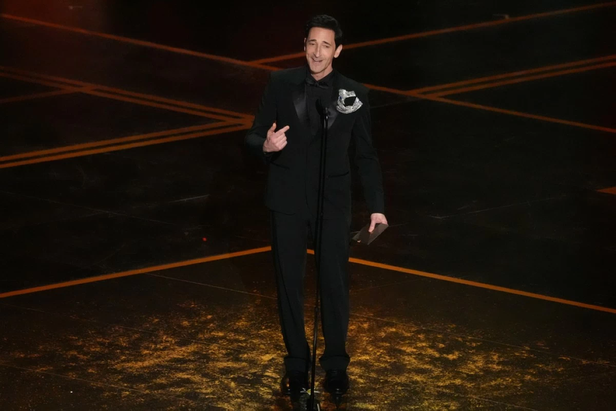 Adrien Brody presents the award for best performance by an actor in a leading role during the Oscars on Sunday, March 15, 2026, at the Dolby Theatre in Los Angeles. (AP Photo/Chris Pizzello)