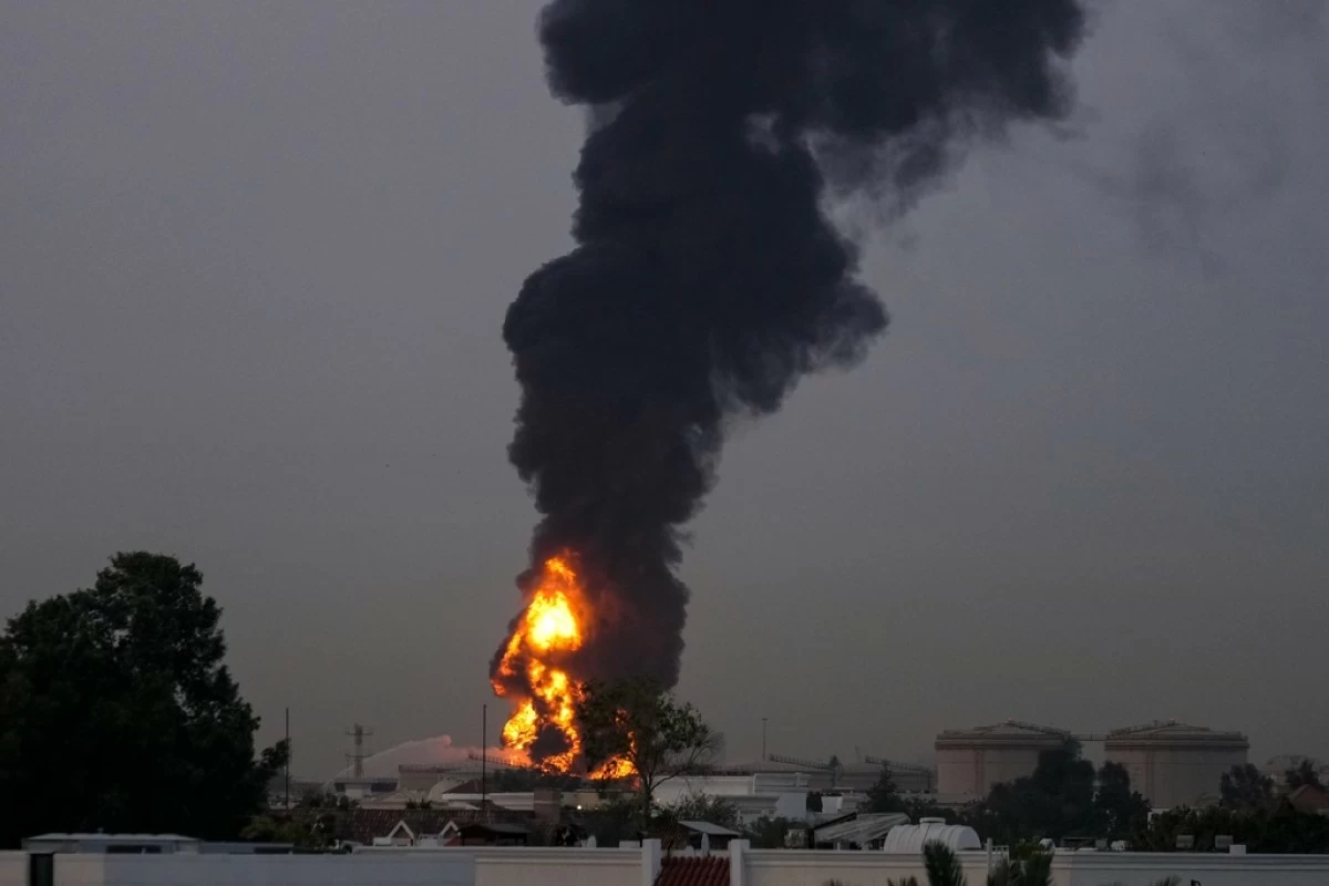 Fire and plumes of smoke rises after s drone struck a fuel tank forcing the temporary suspension of flights. near Dubai International Airport, in United Arab Emirates, early Monday, March 16, 2026. (AP Photo)
