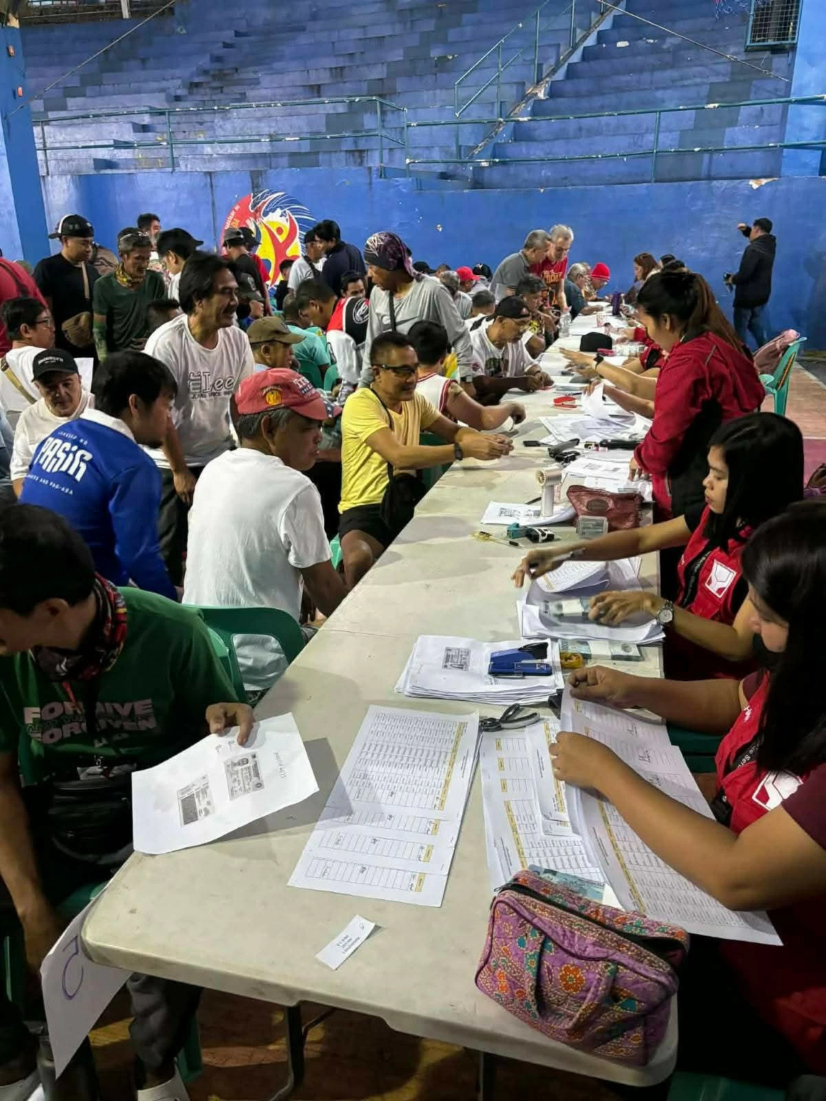 Tricycle drivers in Pasig City line up to receive P5,000 each as fuel subsidy from the national government. (Photos from Pasig PIO)