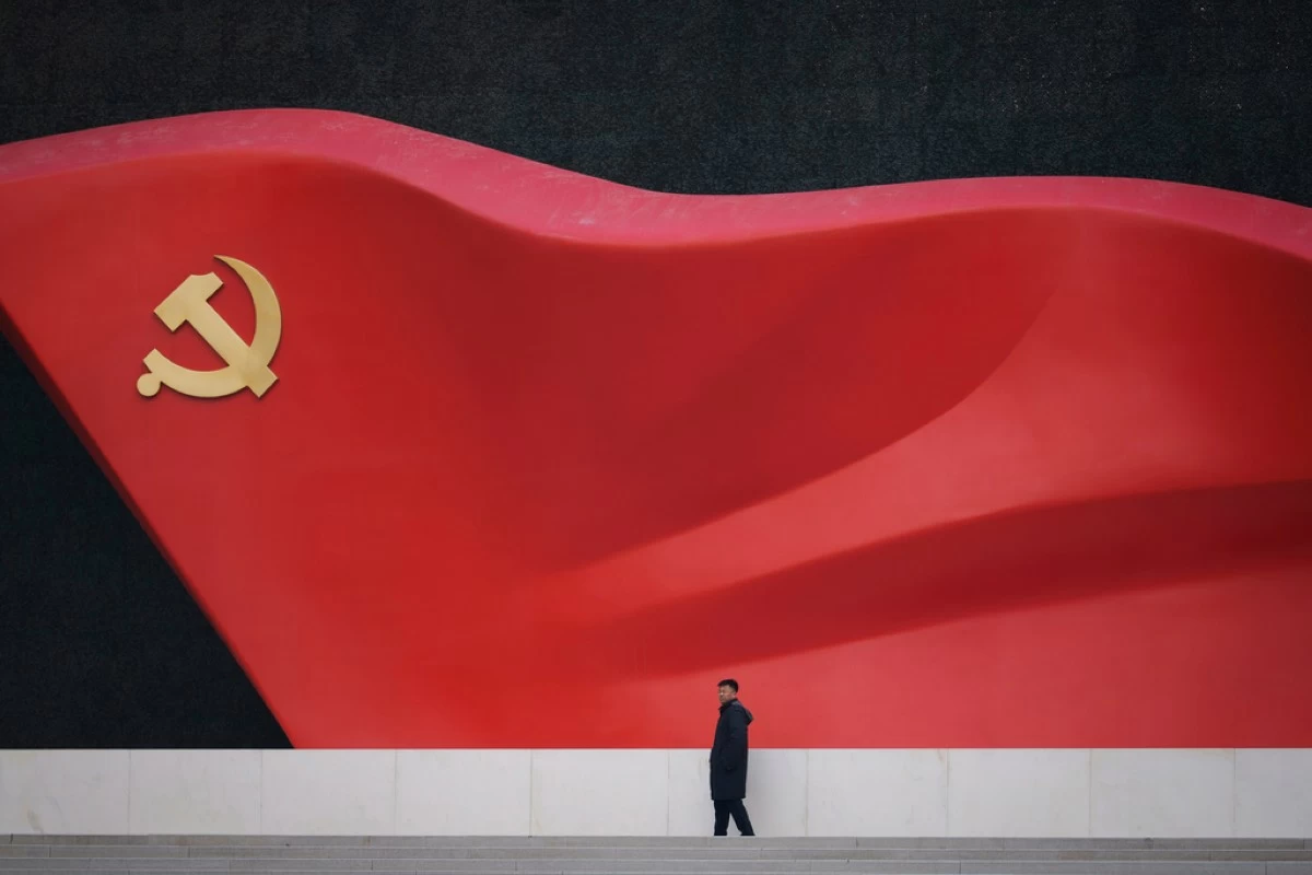 A man walks near a large sculpture of the Communist Party flag at the Chinese Communist Party History Exhibition in Beijing, China, Sunday, March 1, 2026. (AP Photo/Vincent Thian)