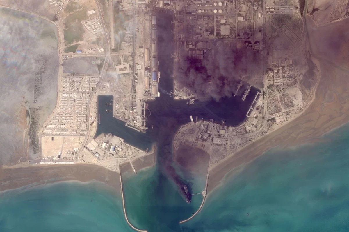 This satellite image from Planet Labs PBC shows fires burning on ships after a U.S. military attack on a port in Bandar Abbas, Iran, March 2, 2026. (Planet Labs PBC via AP)