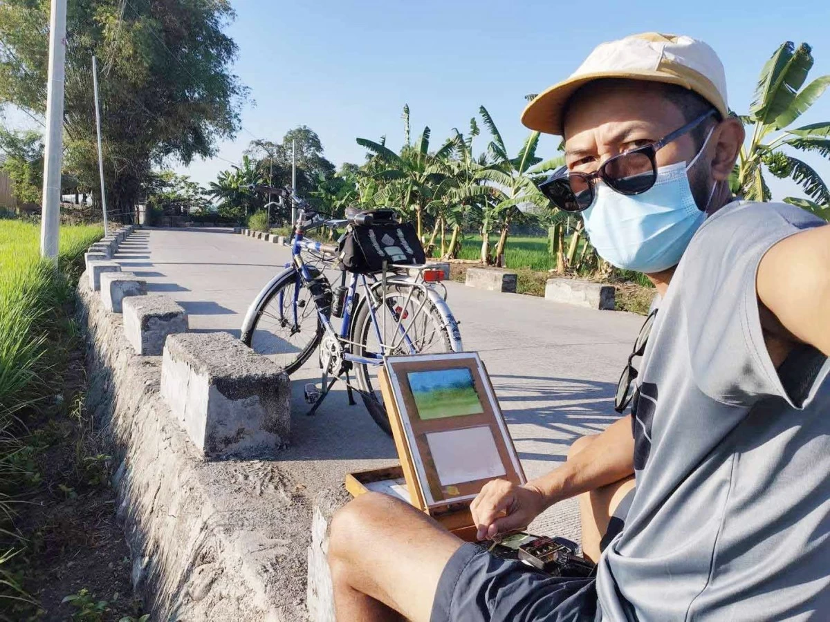 PAINT A PICTURE — Artist Erwin Mallari at work.