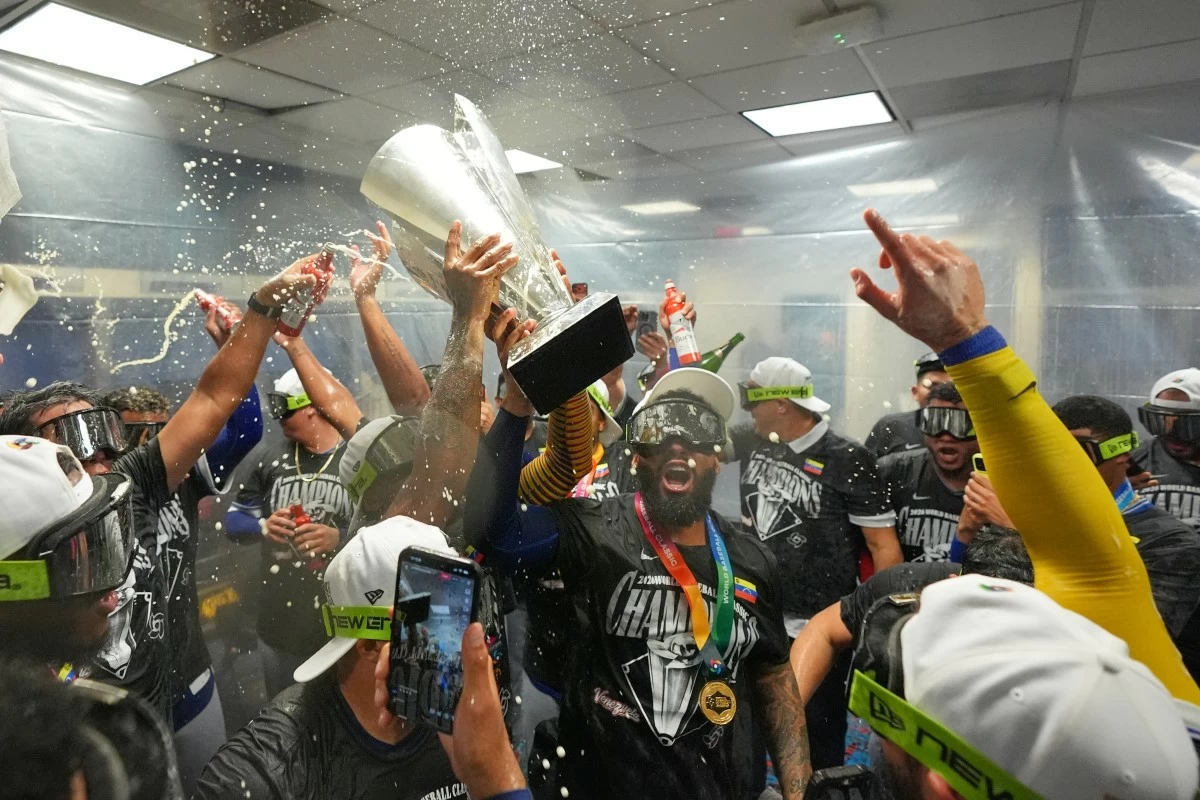 The Venezuela team celebrate with the trophy after defeating the United States in the championship game of the World Baseball Classic, Tuesday, March 17, 2026, in Miami. (AP Photo/Rebecca Blackwell)