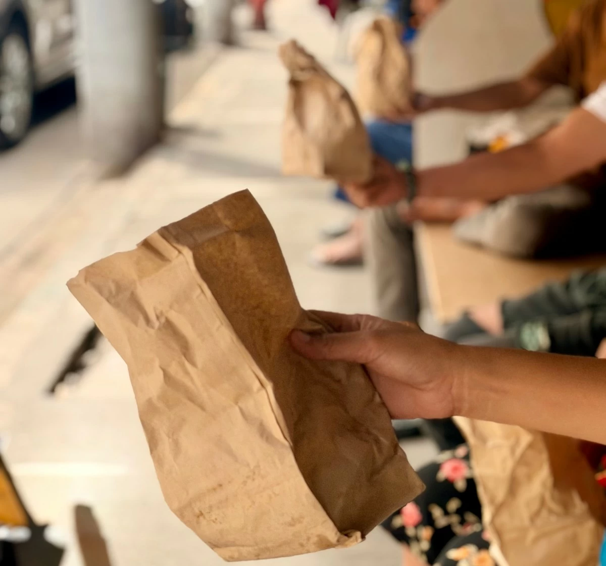 Patients at the outpatient department (OPD) show the bread they received from the PGH chaplaincy feeding program.