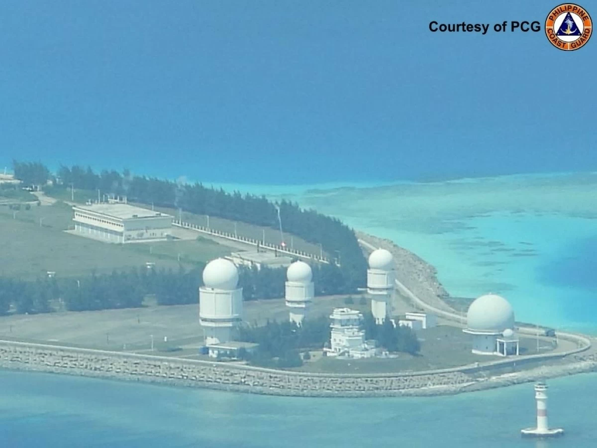 A flare is fired at a Chinese military installation on Panganiban (Mischief) Reef in the West Philippine Sea during a maritime domain awareness flight by the Philippine Coast Guard (PCG) on March 20, 2026. (Photo: PCG)