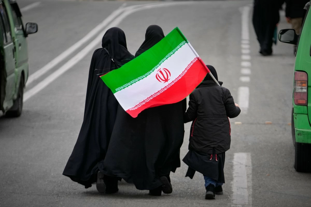 TWO women and a child holding an Iranian flag walk toward the Imam Khomeini Grand Mosque to attend Friday prayers in Tehran, Iran, Friday, March 20, 2026. (AP)