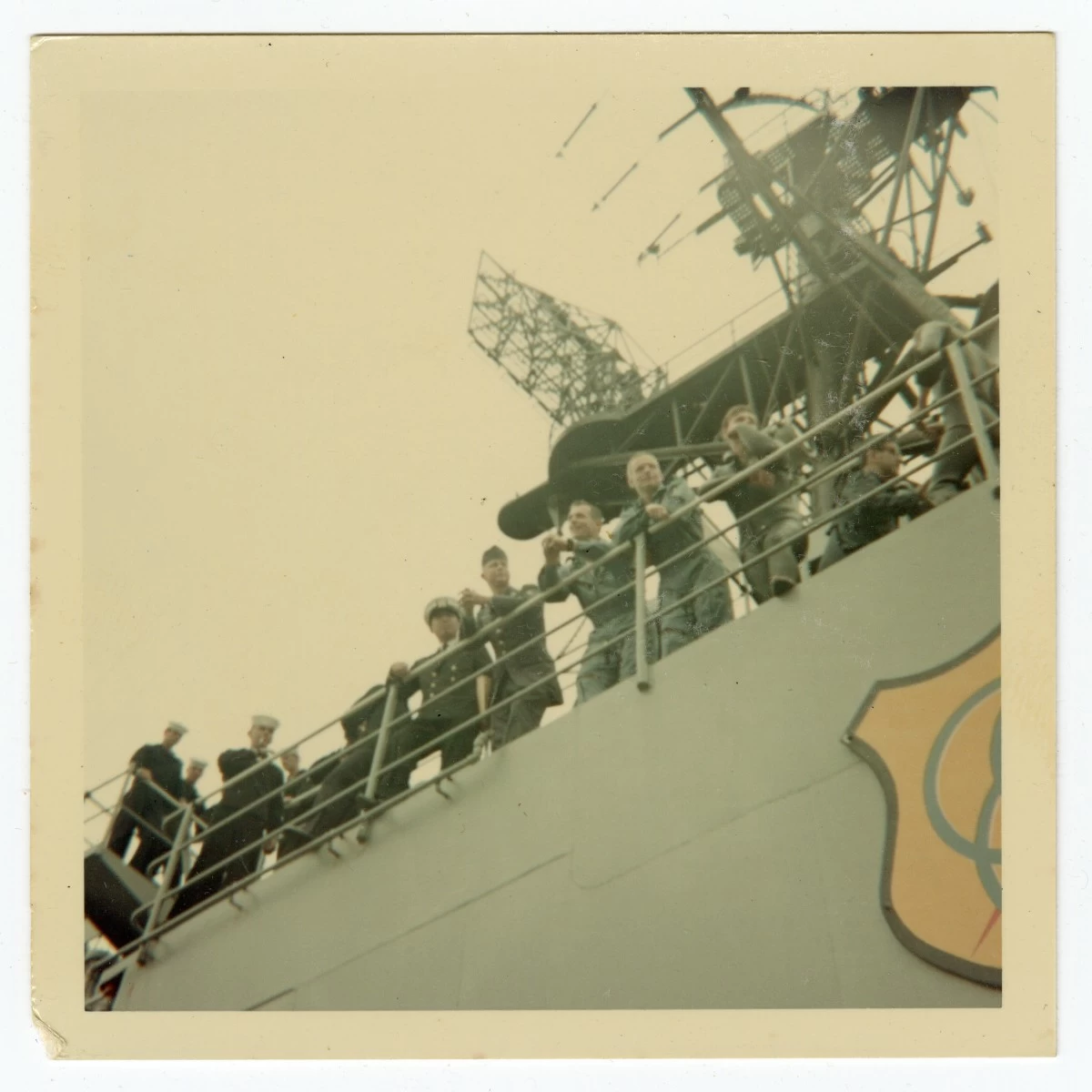 This 1966 image taken by Ron McQueeney shows astronauts Neil Armstrong (second from right) and David Scott (third from right) standing on the deck of the USS Leonard F. Mason at Naha Air Base in Okinawa, Japan. (Ron McQueeney/Ohio History Connection via AP)