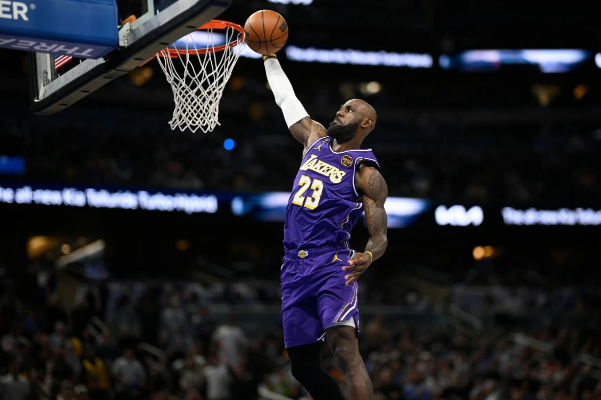 Los Angeles Lakers forward LeBron James (23) scores on a breakaway dunk during the first half of an NBA basketball game against the Orlando Magic, Saturday, March 21, 2026, in Orlando, Fla. (AP Photo/Phelan M. Ebenhack)