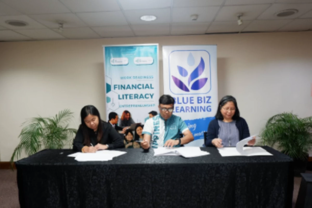 (From left) Paula Patrice Dela Cruz of JA Philippines, executive director Krishna Alejandrino of JA Philippines, and Emilie Grace Nolledo Tan, founder of Blue Biz Learning, formalize their partnership during the signing ceremony.
