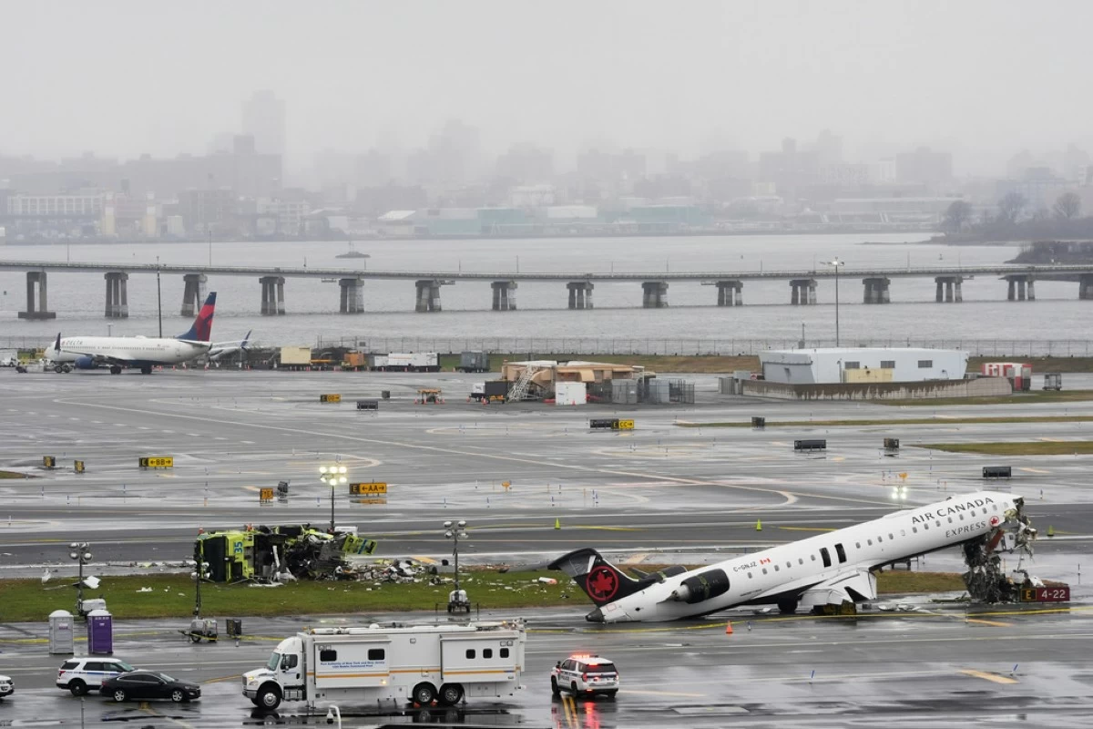 An Air Canada jet and Port Authority fire truck sit on the runway at LaGuardia Airport, Monday, March 23, 2026, after colliding with each other after the jet landed Sunday night in New York. (AP Photo/Seth Wenig)