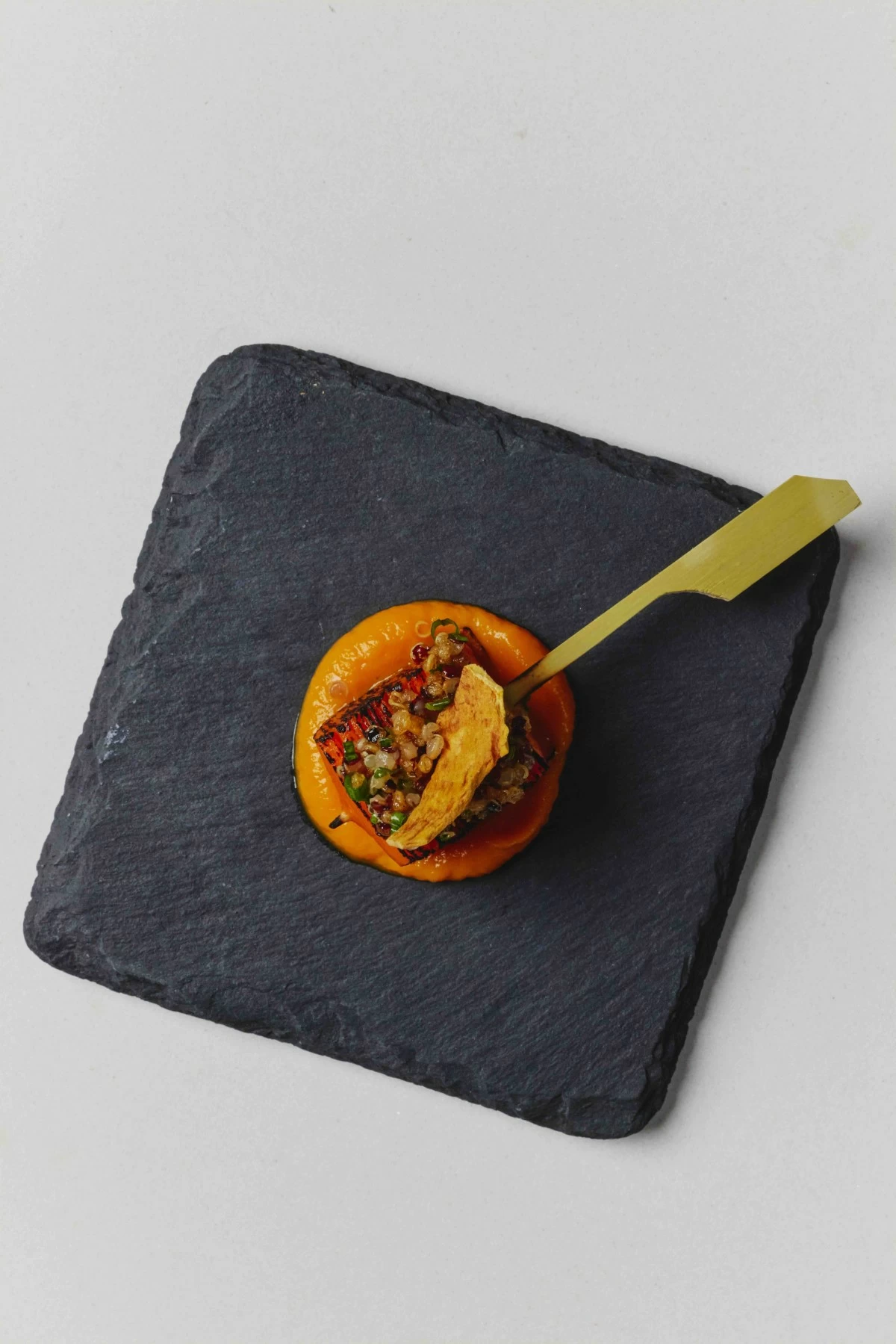 PRIDE PLATES
A trio of vegetable dishes opens the meal, tomato tartare, eggplant “sandwich,” and carrot skewer, each highlighting different textures and techniques