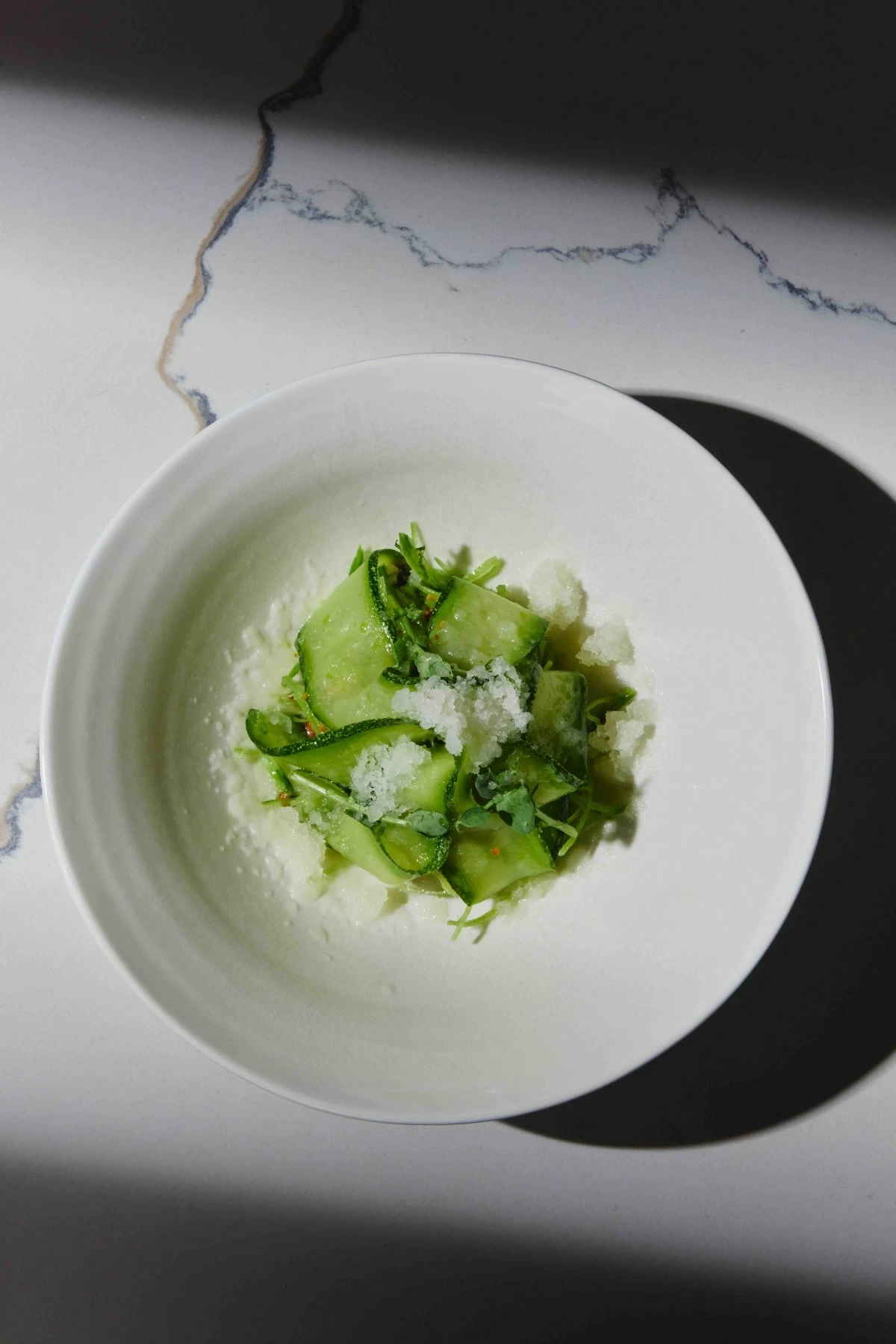 ENVY GREENS Zucchini ribbons with snowpeas and arugula, dressed in white balsamic, with smoked honeydew, pistachios, and a honeydew granita