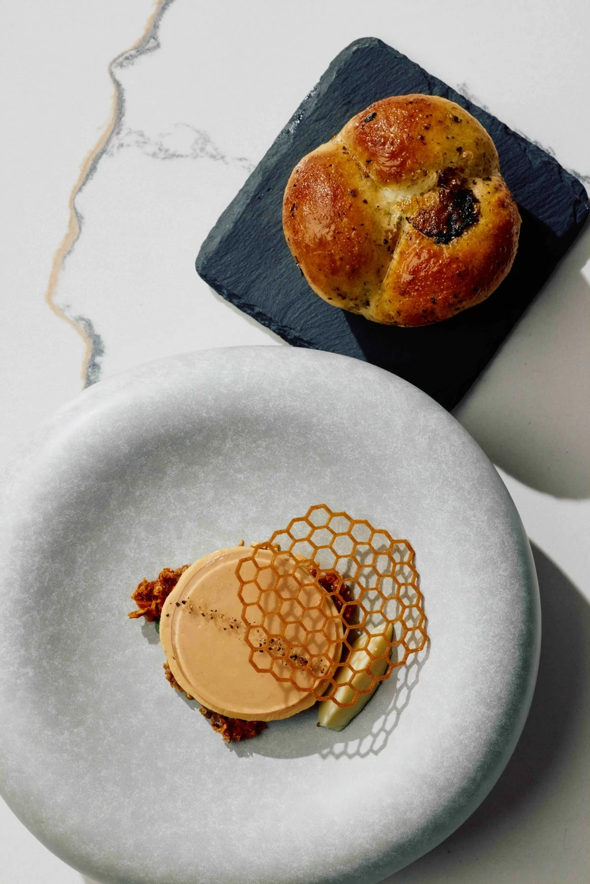 GREED COURSE Truffle brioche paired with foie gras torchon, champagne jelly, cashew streusel, honeycomb, and whipped blue cheese butter