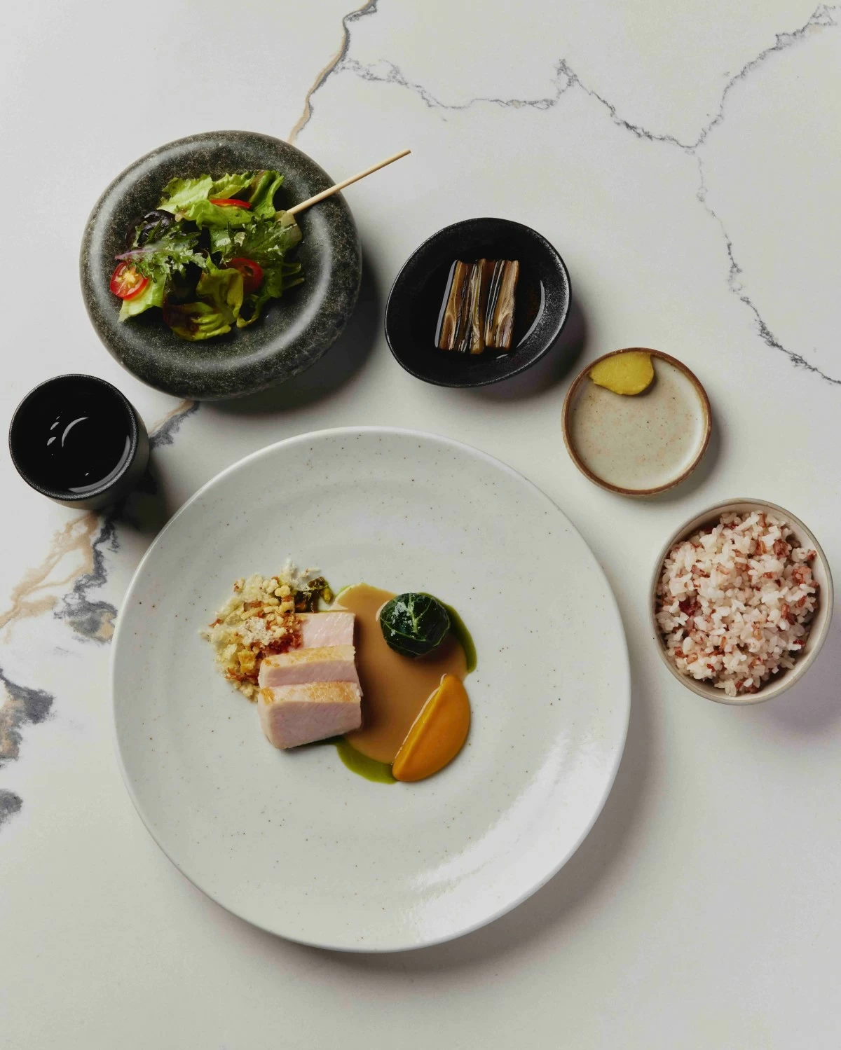 GLUTTONY FEAST A pork-centered spread featuring marinated loin, a pork and shrimp dumpling, chicharron crumble, roasted squash, and a range of sides