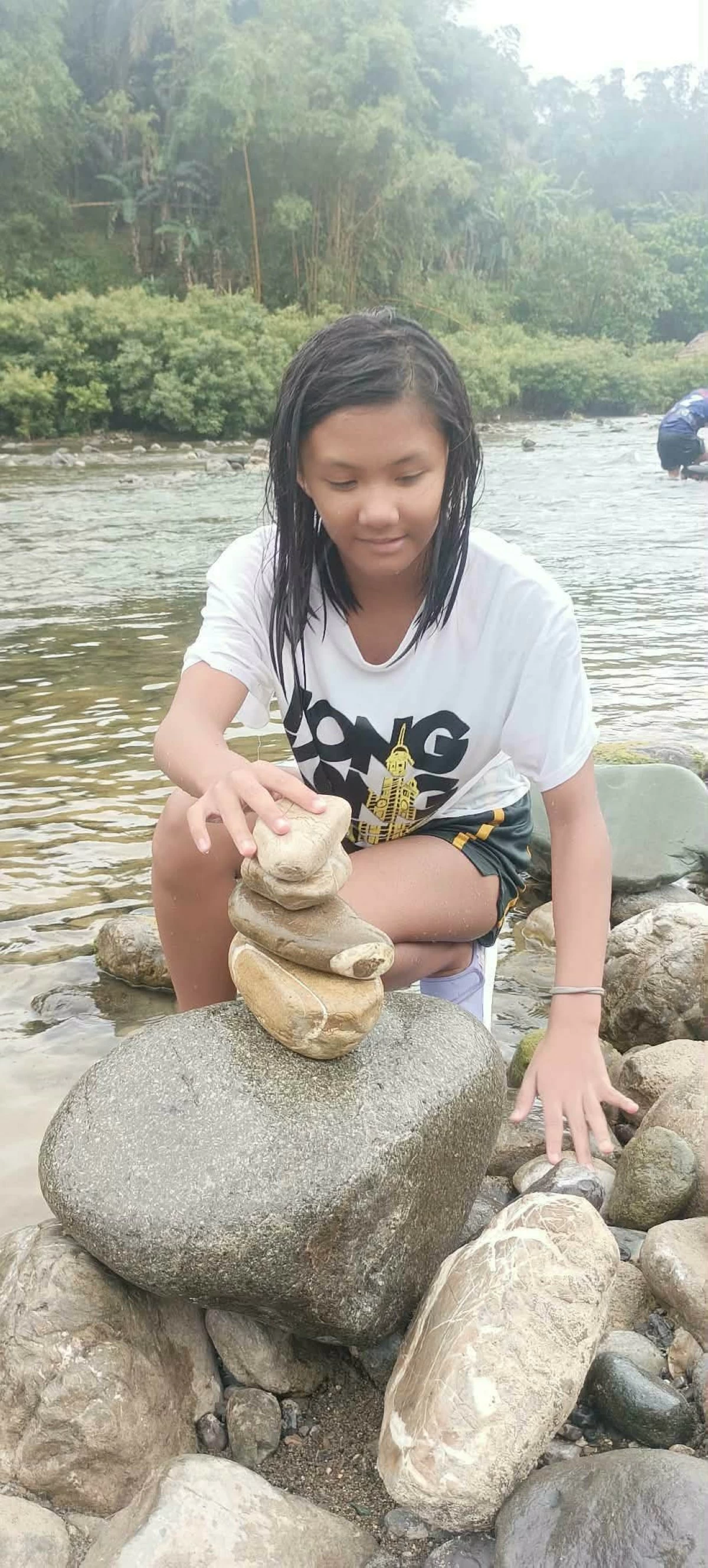 Rock balancing by the river is one of the outdoor activities tourists can enjoy at the camp (photo by Nel Andrade)