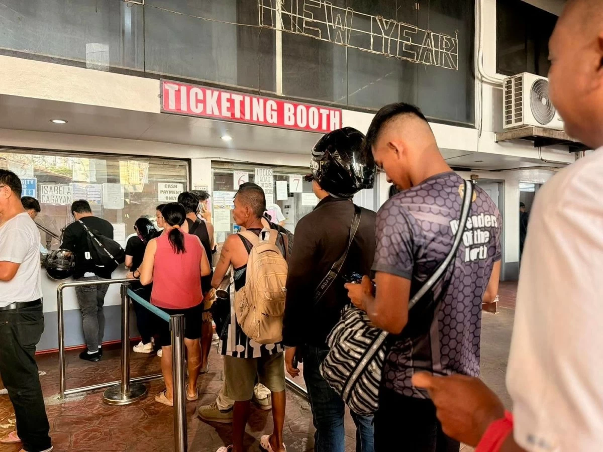 Passengers line up outside the Maria de Leon Trans terminal along Dapitan Street in Sampaloc, Manila, on Tuesday, March 31, as trips to provinces quickly fill up ahead of the Holy Week rush.