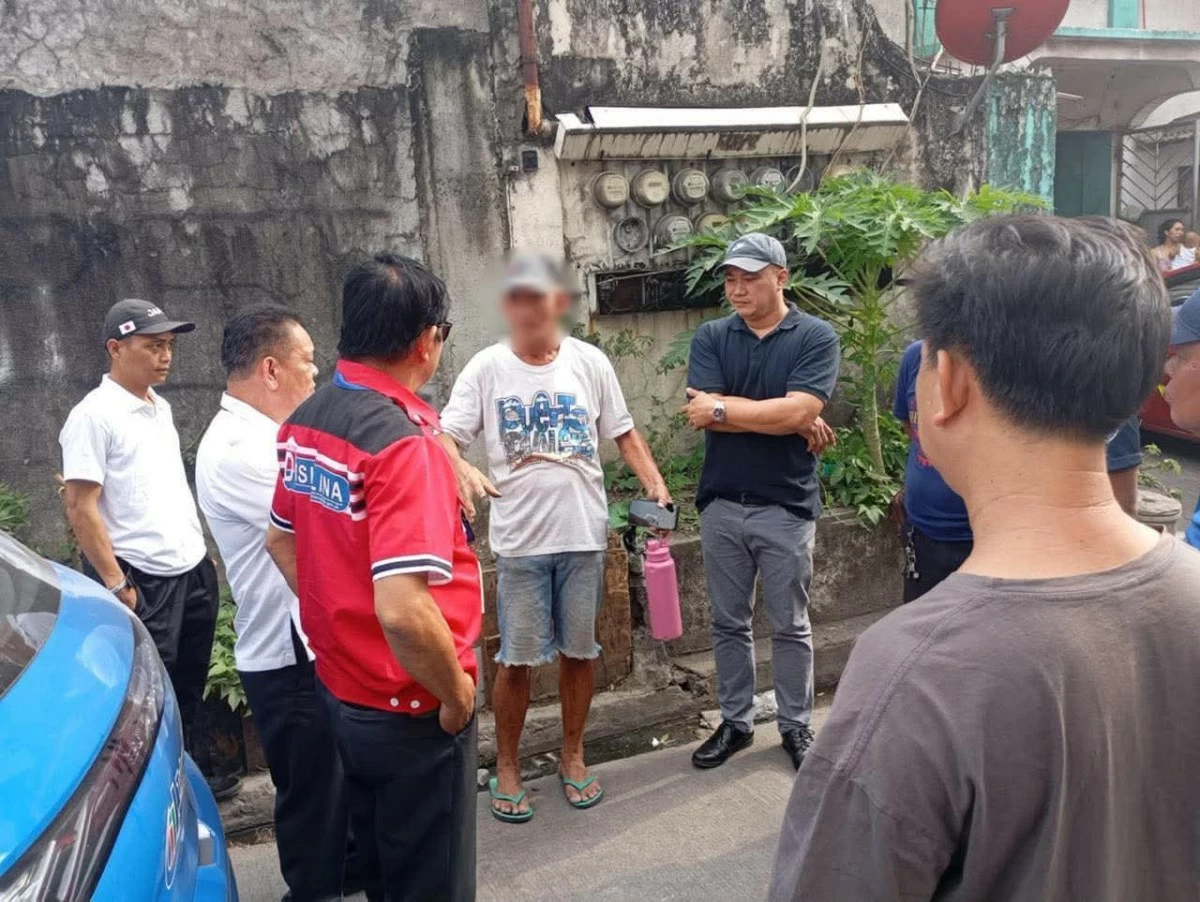 Task Force Disiplina (TFD) personnel arrest a man for illegal dumping in the Tullahan River in Valenzuela City on March 30. (Photo from Valenzuela LGU)
