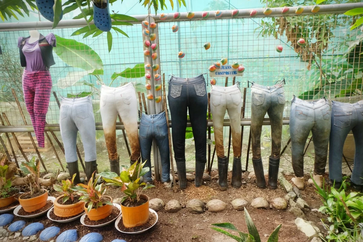 IMAGINATIVE USE — Repurposed denim garments utilized as a composting pit to promote sustainable textile waste management.