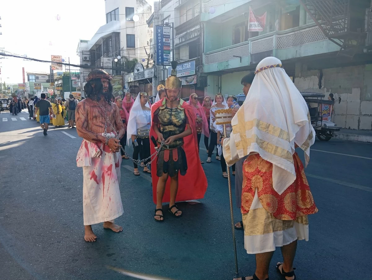 Actors portray their role in the street during 