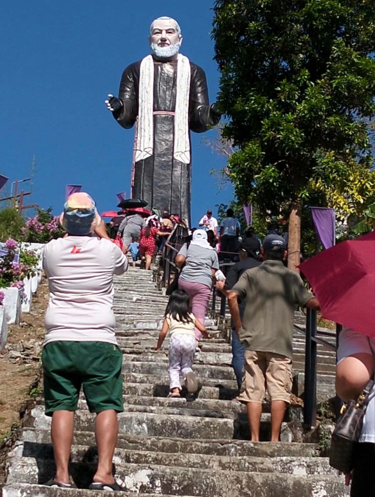 Devotees climb the 150-step stairs toward the 50-foot statue of St. Padre Pio in Barangay Paradise III, City of San Jose Del Monte, Bulacan. (Photo by Freddie Velez) 