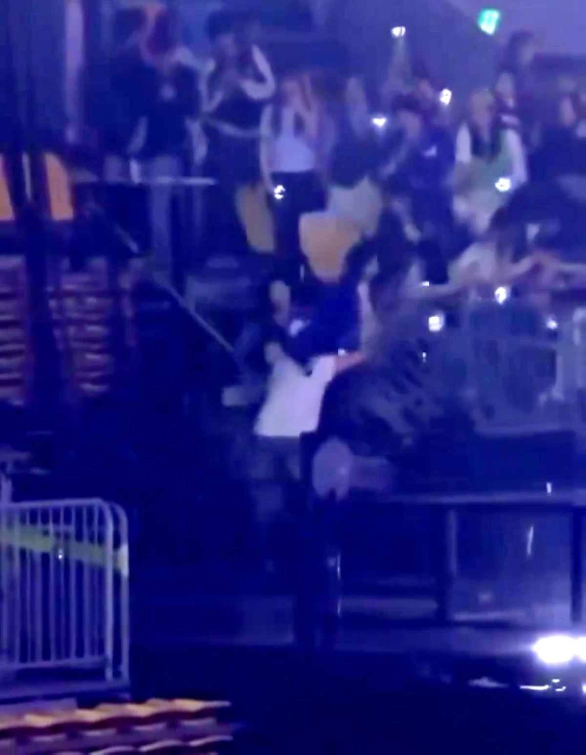 Super Junior's Ryeowook and fans falling after the fence collapsed (Screenshot from justelfsj video on X)