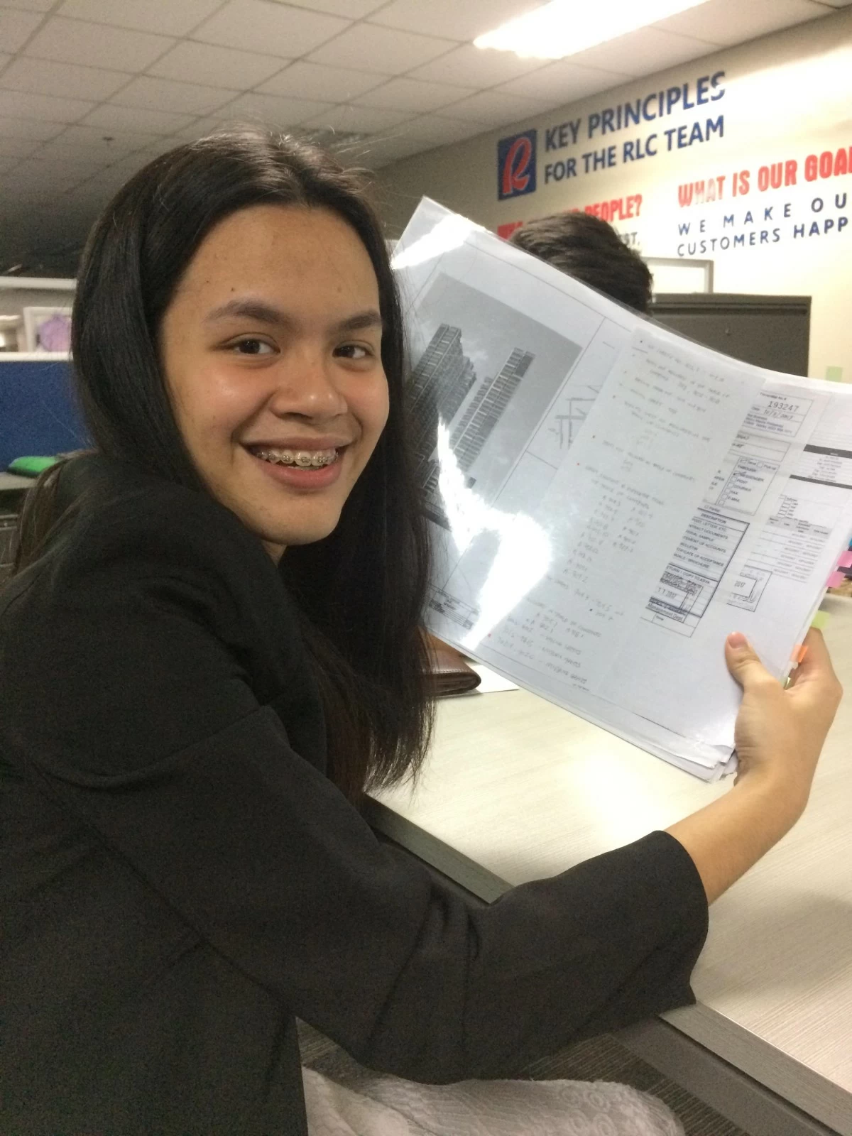 Rheanna studying architectural plans during her internship the summer before her first year of college (left); Rheanna on her 5th year (right)