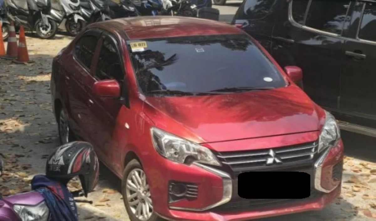 A red Mitsubishi Mirage sedan allegedly used by suspects in a Quezon City diesel pilferage case, which authorities say was later traced through CCTV and linked to a resale scheme. (Photo courtesy of QCPD)