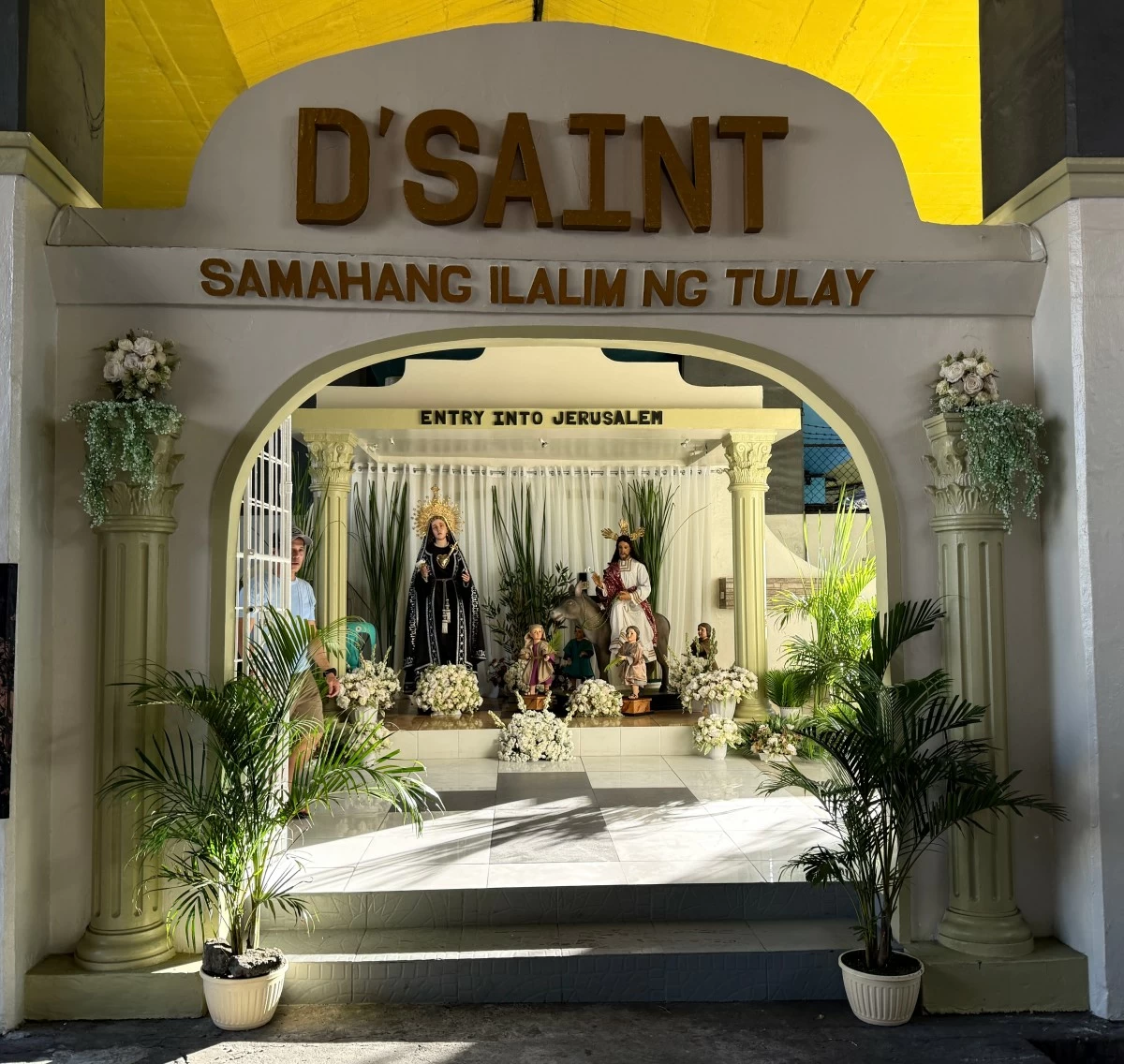 UNDER THE BRIDGE — A grotto underneath a bridge depicting Jesus’ entry into Jerusalem with its organizer’s name prominently displayed at the entrance.