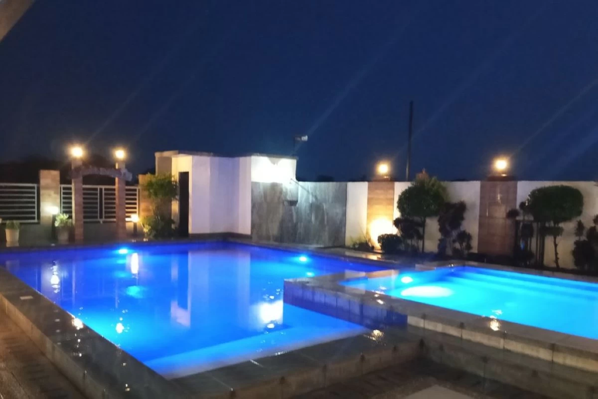 The two lighted pools with jacuzzi at night (photo from Melinda's Garden FB page)