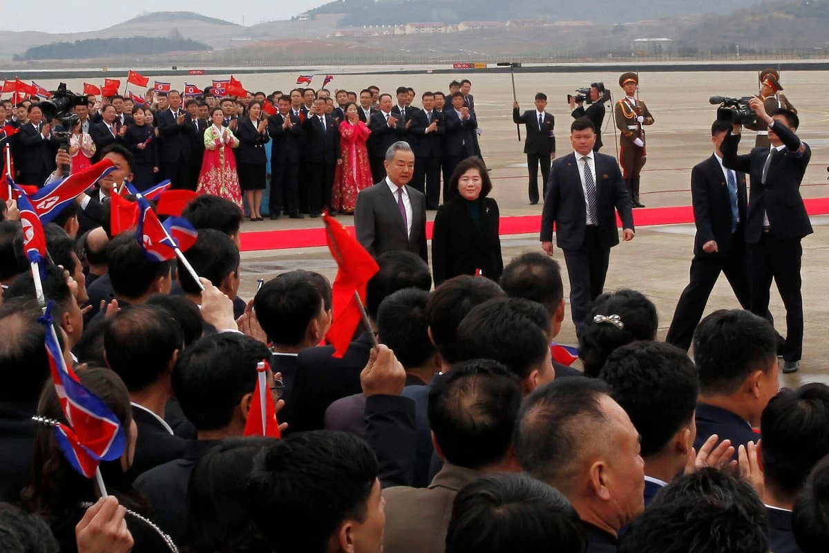 Chinese Foreign Minister Wang Yi, center left, walks with North Korean Foreign Minister Choe Son Hui, center right, on his arrival at the Pyongyang International Airport in Pyongyang, North Korea Thursday, April 9, 2026. (AP Photo/Jon Chol Jin)
