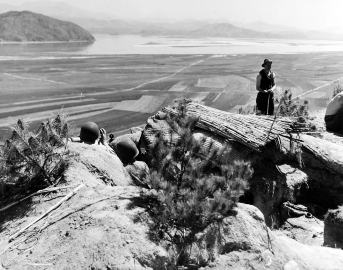 Shore fire control party from Toledo in an observation post overlooking the Han River, Korea, circa late April or May 1951. They are ready to spot and correct the cruiser's gunfire should the enemy appear (Photo:  US Navy / National Archives)

