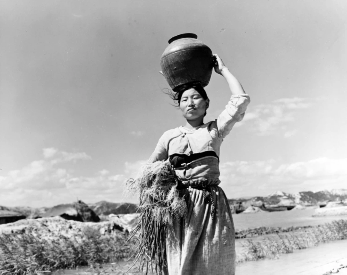 A Korean woman carries her belongings in a jug on her head, while fleeing from Pohang, South Korea. Original photo is dated Oct. 17, 1950. (Photo: US Navy Photograph, now in the collections of the National Archives) 
