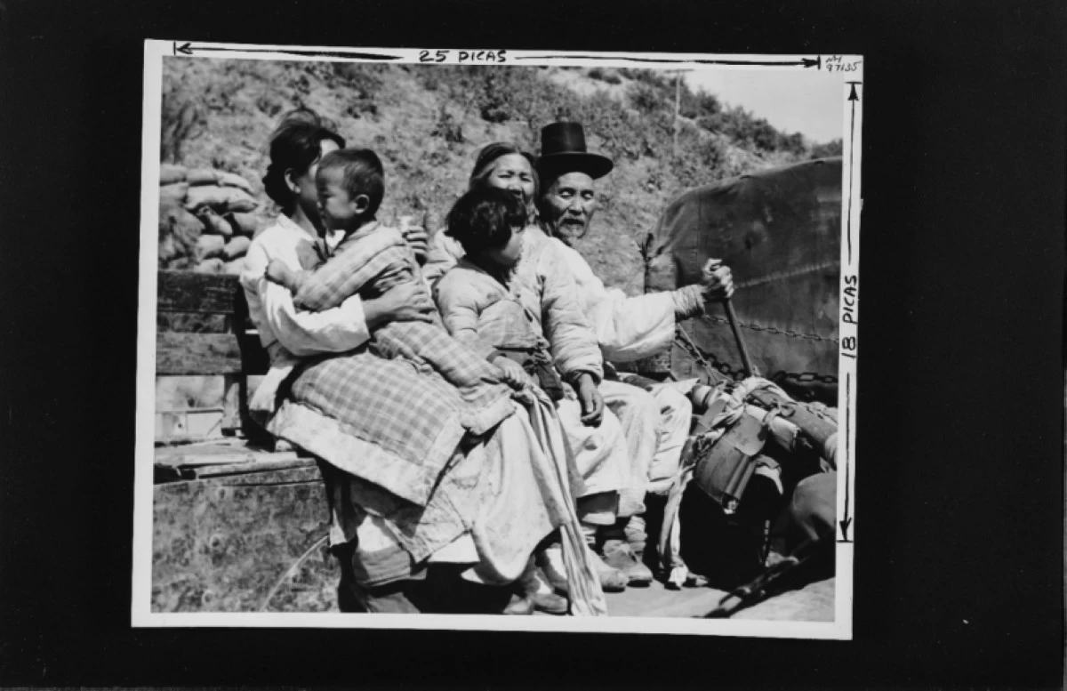
Trip out of danger, aged and young, this family of Koreans are evacuated out of possible danger areas near the front lines by a US Marine transport truck. Photograph and caption released by Commander Naval Forces, Far East, under date of 10 April 1952. (Photo: US Navy, from the All Hands collection at the Naval History and Heritage Command) 

