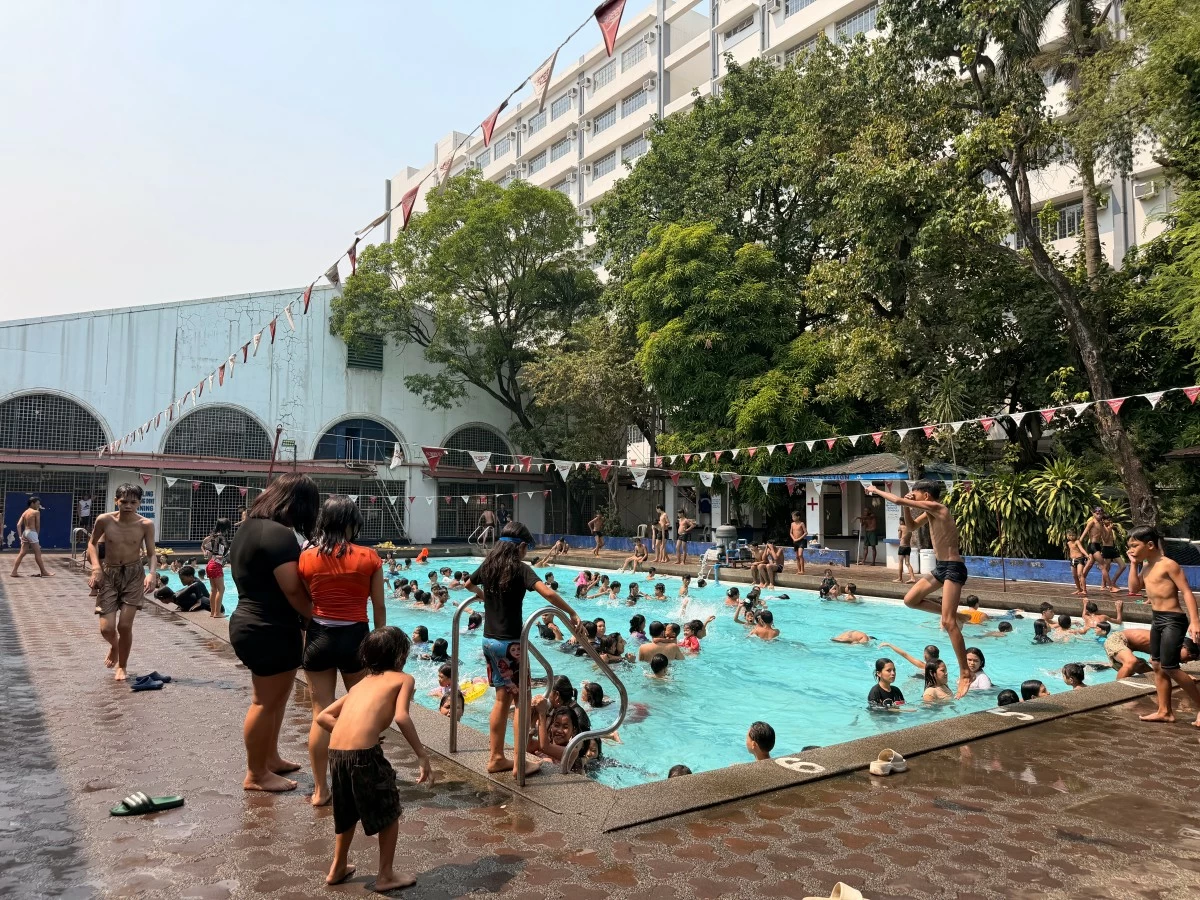 Swimmers enjoy the water at the Dapitan Sports Complex as the city’s free pool program operates on a batch system to manage the growing number of visitors during summer.