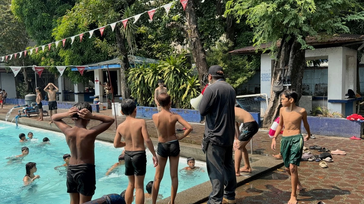 Assistant lifeguard Axel monitors swimmers at the Dapitan Sports Complex in Sampaloc, Manila, reminding visitors to follow safety rules and avoid risky behavior inside the pool area.
