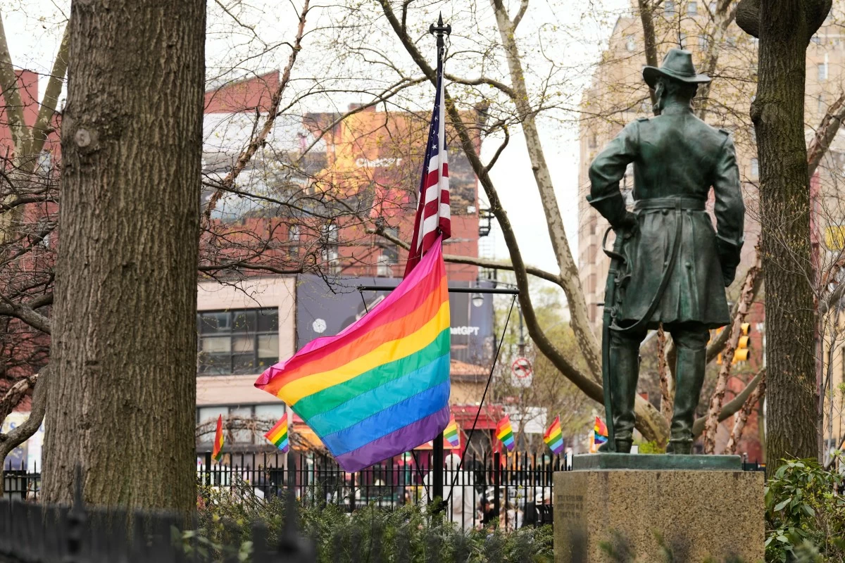 A rainbow Pride flag flies with an American flag at the Stonewall National Monument in New York, Monday, April 13, 2026. (AP Photo/Seth Wenig)