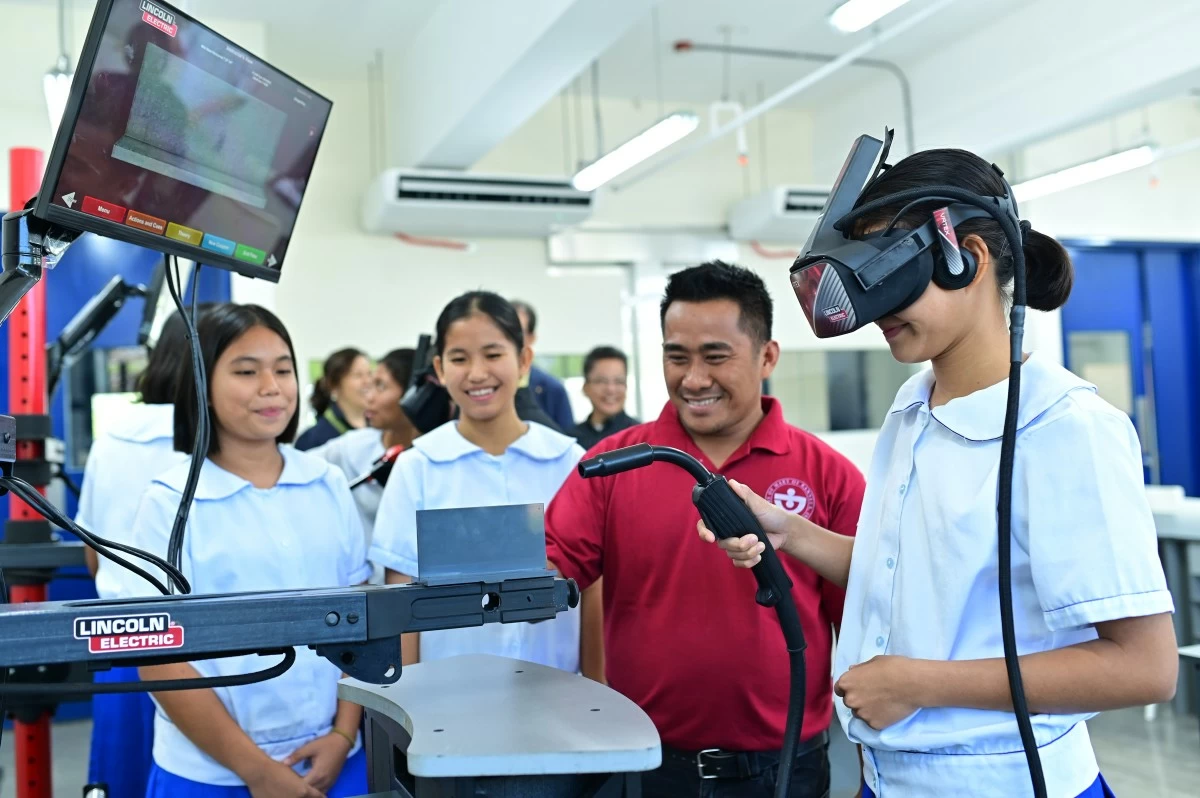 Students use a virtual welding simulator inside the Felicidad T. Sy Hall Digital Transformation Center, where modern equipment helps learners develop technical and vocational skills through immersive digital training.