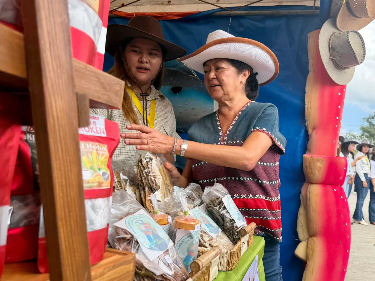 The First Lady and Vinny Marcos tour the exhibition booths during the 30th Rodeo Masbateño Festival. Mrs. Marcos took a close interest in the local crafts, asking vendors about their materials and earmarking several items to be featured in an upcoming exhibition for the ASEAN summit.