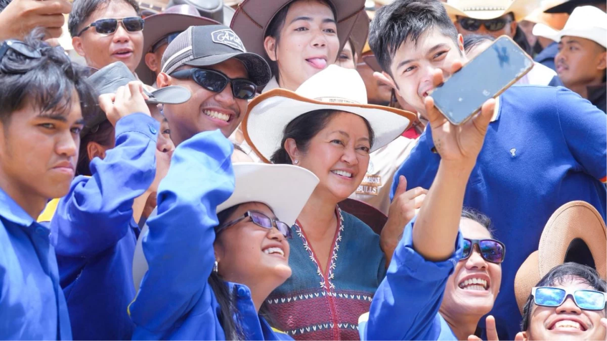 First Lady Liza Araneta-Marcos and her son, Vinny, take a selfie with the local crowd during the opening of the 30th Rodeo Festival in Masbate City last Monday. The First Lady visited the province to support local tourism and trade at the invitation of festival organizers.