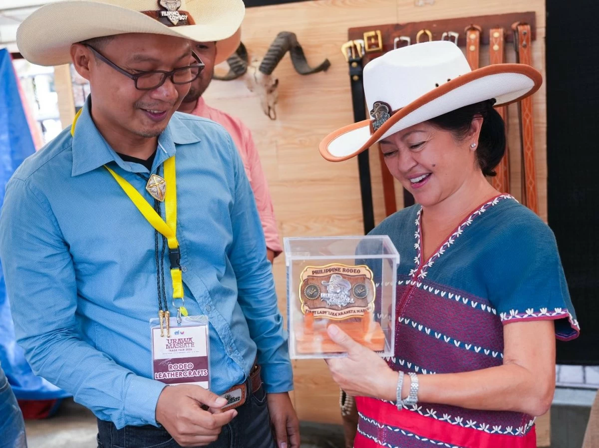 The First Lady and Vinny Marcos tour the exhibition booths during the 30th Rodeo Masbateño Festival. Mrs. Marcos took a close interest in the local crafts, asking vendors about their materials and earmarking several items to be featured in an upcoming exhibition for the ASEAN summit.