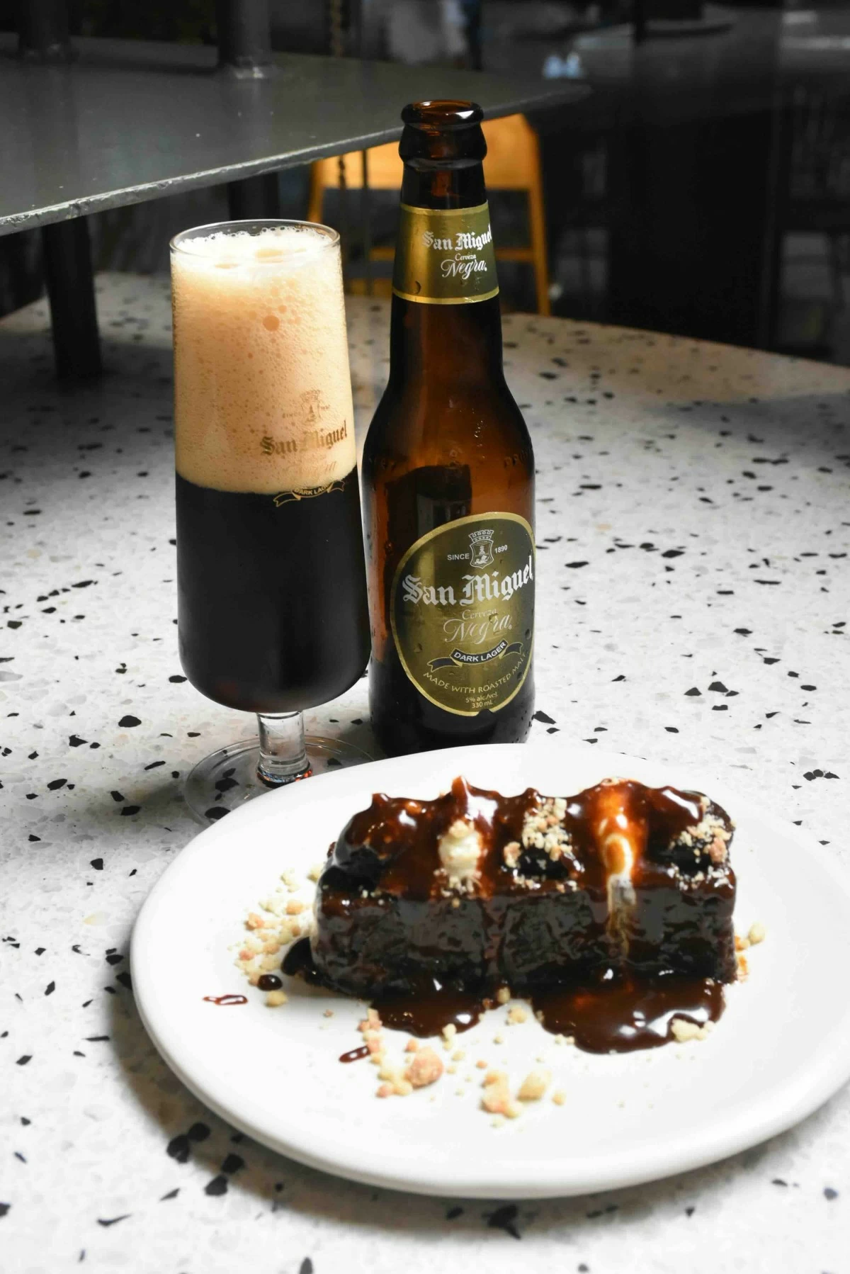 SWEET FINISH Warm walnut date cake with Cerveza Negra, its notes of caramel, coffee, and chocolate echoing the dessert’s richness. (Photo courtesy of SMB)
