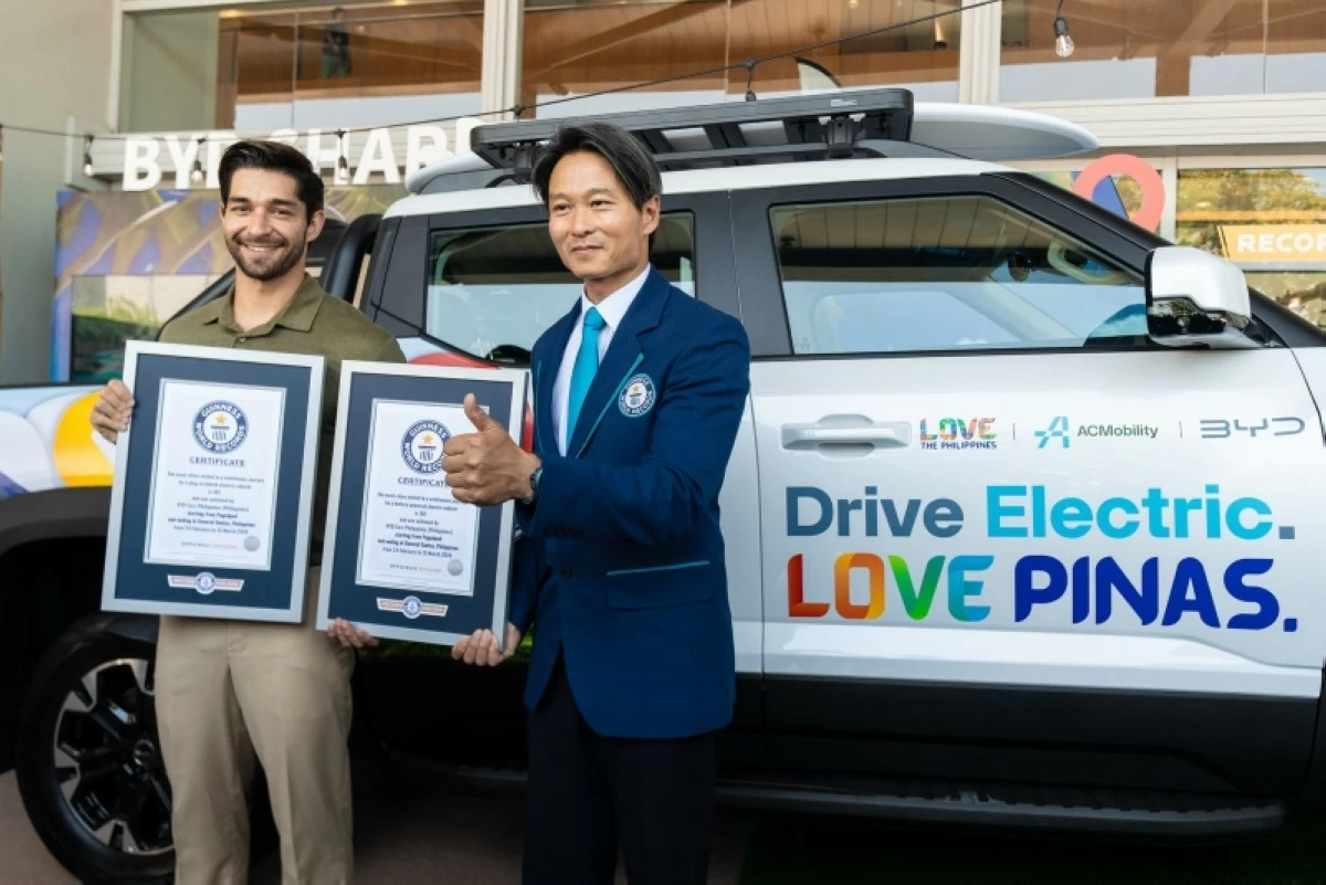 BYD Cars Philippines is awarded two Guinness World Records for the Drive Electric. Love Pinas Campaign. From left to right: Wil Dasovich, Lead Navigator and Peter Yang, Guinness World Records Adjudicator
