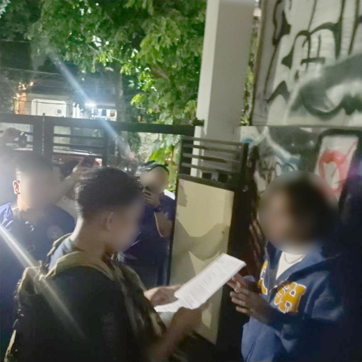 CIDG operatives serve the search arrest warrant on a house in Quezon City where rapper Hev Abi was arrested allegedly for loose gun-related violation. (photo: CIDG) 