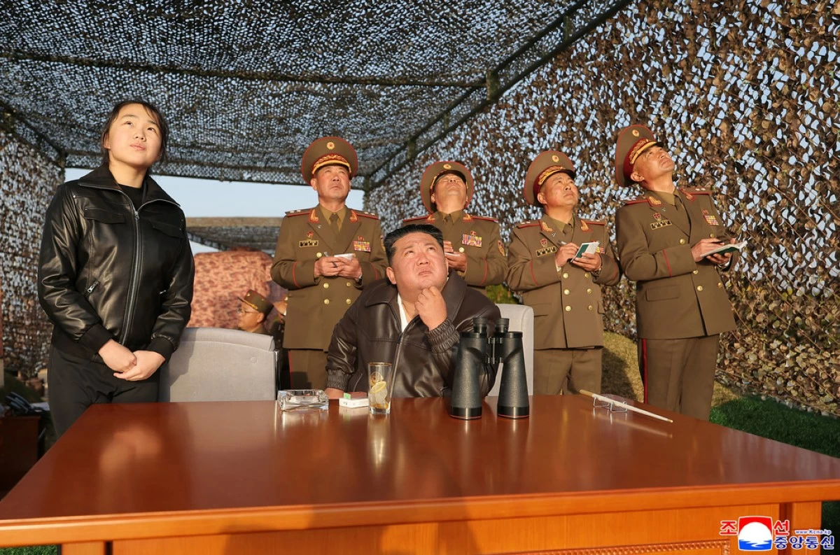In this photo provided by the North Korean government, its leader Kim Jong Un, sitting, with his daughter observes what it says a test launch of an upgraded surface-to-surface ballistic missile at an undisclosed place in North Korea Sunday, April 19, 2026. (Korean Central News Agency/Korea News Service via AP)