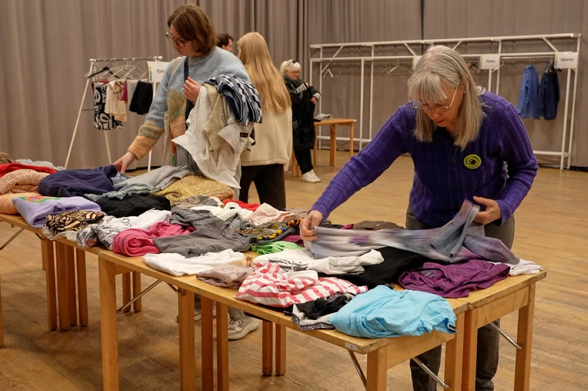 Meg Goldmann, right, a volunteer with the Swedish Society for Nature Conservation, folds secondhand clothes at a clothing swap event in Stockholm, Sweden, Saturday, April 19. 2026. (AP Photo/Chisato Tanaka)