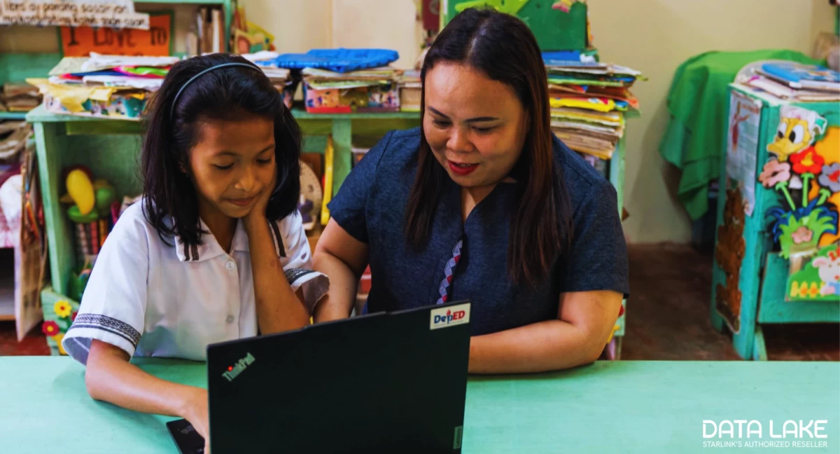 Students and teachers access satellite-enabled internet connectivity at New Rizal Elementary School, Zamboanga del Norte